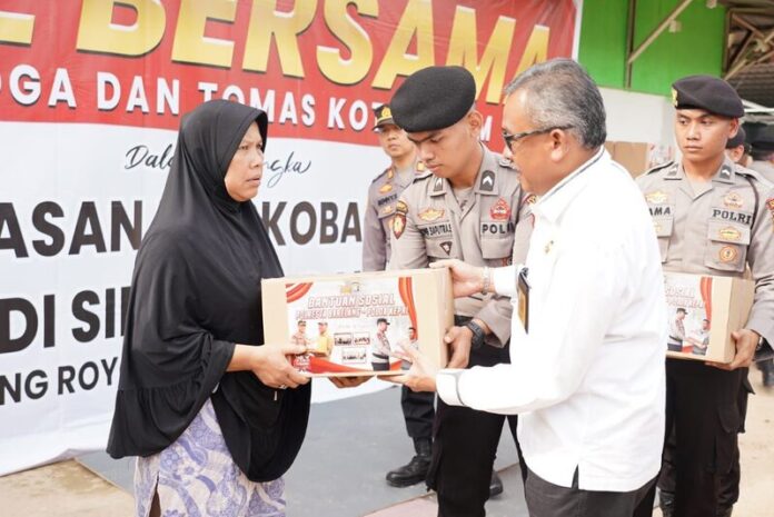 Sekda Kota Batam Jeffridin menyerahkan bantuan sosial ke masyarakat di Kampung Aceh, Simpang Dam, Muka Kuning, Jumat (31/3/2023). F Humas Pemko.